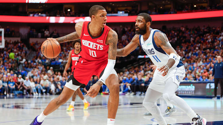 Apr 7, 2024; Dallas, Texas, USA; Dallas Mavericks guard Kyrie Irving (11) guards Houston Rockets forward Jabari Smith Jr. (10) during the third quarter at American Airlines Center. Mandatory Credit: Andrew Dieb-Imagn Images