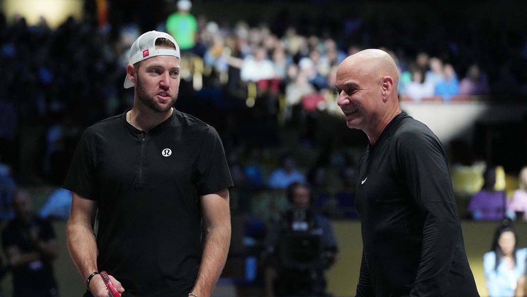 Feb 4, 2024; Hollywood, FL 33314, FL, USA;  Andre Agassi (right) and Jack Sock discuss strategy during Pickleball Slam 2 at Hard Rock Live at Seminole Hard Rock Hotel & Casino. Mandatory Credit: Jim Rassol-USA TODAY Sports