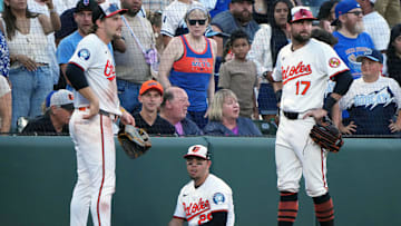 Jul 10, 2025; Baltimore, MD, USA; Baltimore Orioles third baseman Ramon Urias (29) sits between shortstop Gunnar Henderson (2) and outfielder Colton Cowser (17) after making a diving catch of a foul ball against the New York Mets at Oriole Park at Camden Yards. Mandatory Credit: Mitch Stringer-Imagn Images