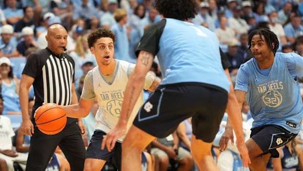 Oct 4, 2025; Charlotte, NC, USA; North Carolina Tar Heels guard Kyan Evans (0) with the ball as forward Zayden High