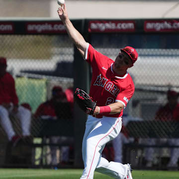Mar 10, 2025; Tempe, Arizona, USA; Los Angeles Angels outfielder Mike Trout (27) throws the ball in against the Colorado Rockies in the second inning at Tempe Diablo Stadium. Mandatory Credit: Rick Scuteri-Imagn Images