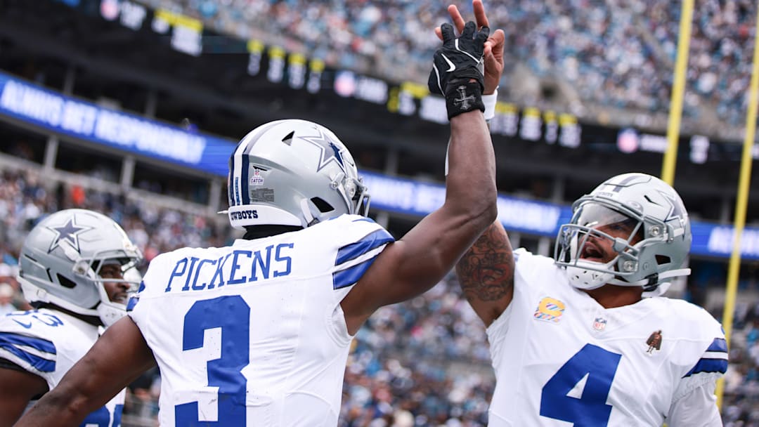 Dallas Cowboys wide receiver George Pickens celebrates with quarterback Dak Prescott at Bank of America Stadium. 