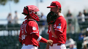 Cincinnati Reds catcher Jose Trevino (35) talks with Cincinnati Reds pitcher Brady Singer (51)