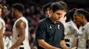 Cincinnati Bearcats head coach Wes Miller looks at his notes in the second half of the NCAA basketball game between the Cincinnati Bearcats and the West Virginia Mountaineers at Fifth Third Arena in Cincinnati on Sunday, Feb. 2, 2025. The Bearcats lost, 63-50.