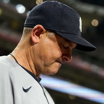 New York Yankees manager Aaron Boone (17) checks his notes before the ninth inning of the MLB interleague game between the Cincinnati Reds and the New York Yankees at Great American Ball Park in downtown Cincinnati on Monday, June 23, 2025.