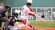 Sep 1, 2025; Boston, Massachusetts, USA; Boston Red Sox third baseman Alex Bregman (2) hits a double during the first inning against the Cleveland Guardians at Fenway Park. Mandatory Credit: Eric Canha-Imagn Images