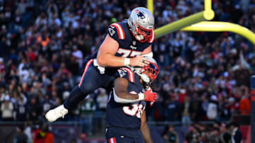 iOct 27, 2024; Foxborough, Massachusetts, USA; New England Patriots running back Rhamondre Stevenson (38) celebrates with center Ben Brown (77) after scoring a touchdown against the New York Jets during the second half at Gillette Stadium. Mandatory Credit: Brian Fluharty-Imagn Images
