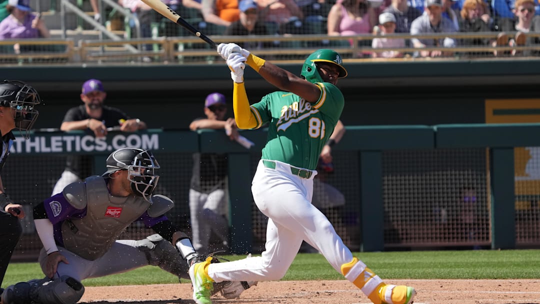 Mar 6, 2026; Mesa, Arizona, USA; Athletics shortstop Leo de Vries (83) hits against the Colorado Rockies in the second inning at Hohokam Stadium. Mandatory Credit: Rick Scuteri-Imagn Images