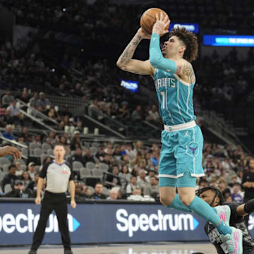 Mar 14, 2025; San Antonio, Texas, USA; Charlotte Hornets guard LaMelo Ball (1) shoots over San Antonio Spurs guard Stephon Castle (5) during the first half at Frost Bank Center. Mandatory Credit: Scott Wachter-Imagn Images