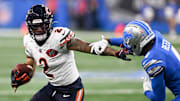 Sep 14, 2025; Detroit, Michigan, USA; Chicago Bears wide receiver DJ Moore (2) carries the ball defended by Detroit Lions cornerback D.J. Reed (4) during the first quarter of the game at Ford Field. Mandatory Credit: Lon Horwedel-Imagn Images