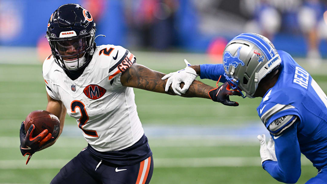 Sep 14, 2025; Detroit, Michigan, USA; Chicago Bears wide receiver DJ Moore (2) carries the ball defended by Detroit Lions cornerback D.J. Reed (4) during the first quarter of the game at Ford Field.