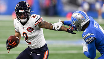 Sep 14, 2025; Detroit, Michigan, USA; Chicago Bears wide receiver DJ Moore (2) carries the ball defended by Detroit Lions cornerback D.J. Reed (4) during the first quarter of the game at Ford Field.