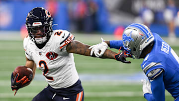Sep 14, 2025; Detroit, Michigan, USA; Chicago Bears wide receiver DJ Moore (2) carries the ball defended by Detroit Lions cornerback D.J. Reed (4) during the first quarter of the game at Ford Field. Mandatory Credit: Lon Horwedel-Imagn Images