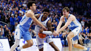 Dec 2, 2025; Lexington, Kentucky, USA; Kentucky Wildcats guard Otega Oweh (00) drives to the basket against North Carolina Tar Heels guard Luka Bogavac (44) and center Henri Veesaar (13) during the second half at Rupp Arena at Central Bank Center. Mandatory Credit: Jordan Prather-Imagn Images