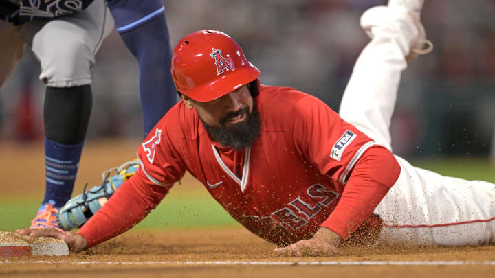 Apr 9, 2024; Anaheim, California, USA;  Los Angeles Angels third base Anthony Rendon (6) beats the tag as he dives back to first in the fourth inning against the Tampa Bay Rays at Angel Stadium. Mandatory Credit: Jayne Kamin-Oncea-USA TODAY Sports