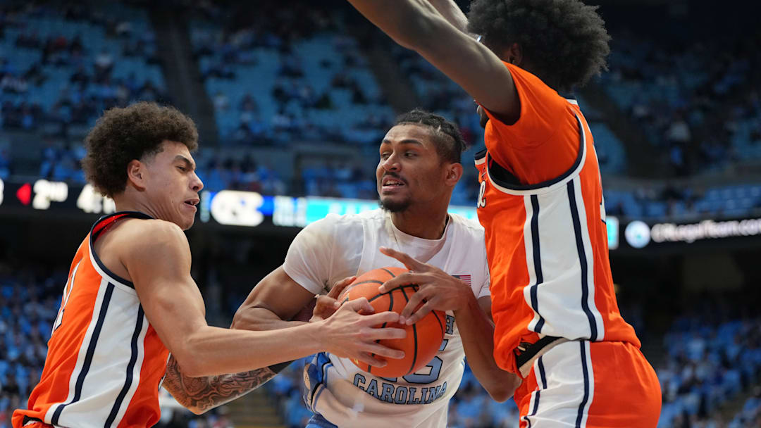 Feb 2, 2026; Chapel Hill, North Carolina, USA; North Carolina Tar Heels forward Jarin Stevenson (15) with the ball as Syracuse Orange guard Naithan George (11) and forward Ibrahim Souare (10) defend in the second half at Dean E. Smith Center. Mandatory Credit: Bob Donnan-Imagn Images