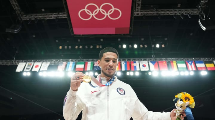 Aug 7, 2021; Saitama, Japan; United States guard Devin Booker celebrates after winning the gold medal during the Tokyo 2020 Olympic Summer Games at Saitama Super Arena. Mandatory Credit: Kyle Terada-USA TODAY Sports