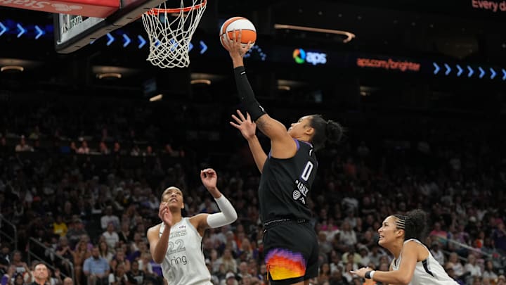 Jun 29, 2025; Phoenix, Arizona, USA; Phoenix Mercury forward Satou Sabally (0) scores against the Las Vegas Aces in the second half at Footprint Center. Mandatory Credit: Rick Scuteri-Imagn Images