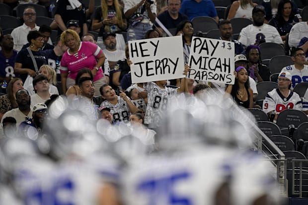 Fans hold up signs for Dallas Cowboys defensive end Micah Parsons during a game against the Baltimore Ravens