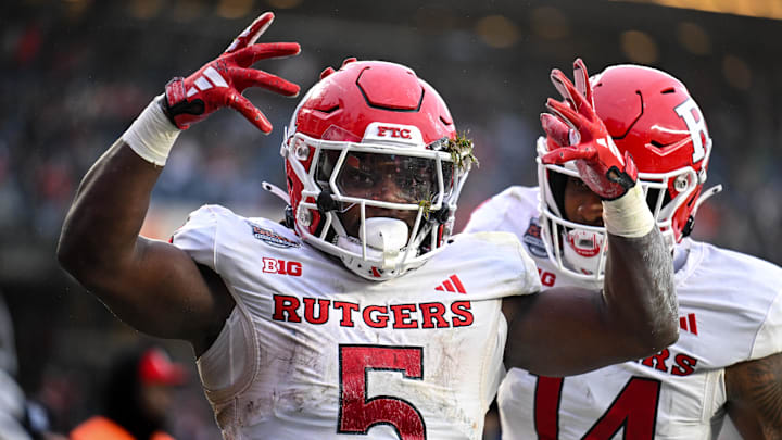 Dec 28, 2023; Bronx, NY, USA; Rutgers Scarlet Knights running back Kyle Monangai (5) celebrates his touchdown against Miami Hurricanes during the second quarter with Rutgers Scarlet Knights wide receiver Isaiah Washington (14) at Yankee Stadium. Mandatory Credit: Mark Smith-Imagn Images