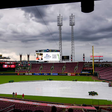 Fans make their ways into the stadium as a rain delay is announced before the first inning of the MLB National League game between the Cincinnati Reds and the Washington Nationals at Great American Ball Park in downtown Cincinnati on Friday, May 2, 2025.