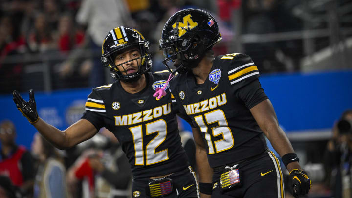 Dec 29, 2023; Arlington, TX, USA; Missouri Tigers defensive back Dreyden Norwood (12) and defensive back Daylan Carnell (13) celebrate a defensive stop against the Ohio State Buckeyes during the second quarter at AT&T Stadium. Mandatory Credit: Jerome Miron-USA TODAY Sports