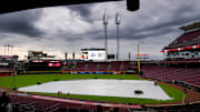 Fans make their ways into the stadium as a rain delay is announced before the first inning of the MLB National League game between the Cincinnati Reds and the Washington Nationals at Great American Ball Park in downtown Cincinnati on Friday, May 2, 2025.