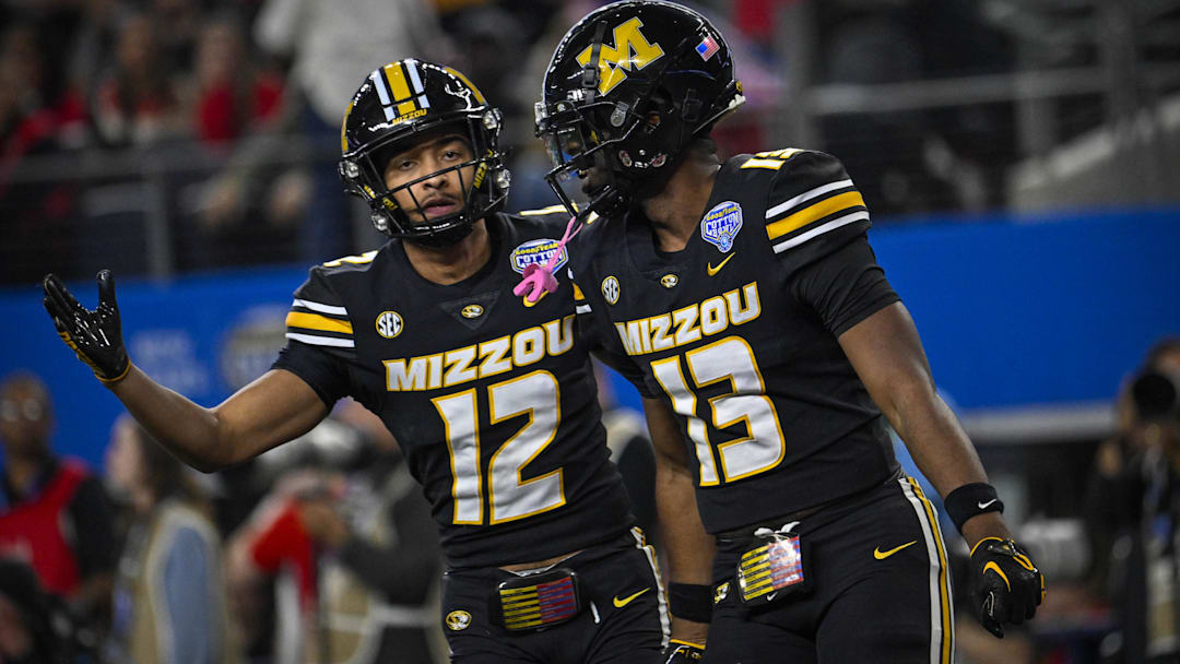 Dec 29, 2023; Arlington, TX, USA; Missouri Tigers defensive back Dreyden Norwood (12) and defensive back Daylan Carnell (13) celebrate a defensive stop against the Ohio State Buckeyes during the second quarter at AT&T Stadium. Mandatory Credit: Jerome Miron-Imagn Images Dec 29, 2023; Arlington, TX, USA; Missouri Tigers defensive back Dreyden Norwood (12) and defensive back Daylan Carnell (13) celebrate a defensive stop against the Ohio State Buckeyes during the second quarter at AT&T Stadium. Mandatory Credit: Jerome Miron-Imagn Images