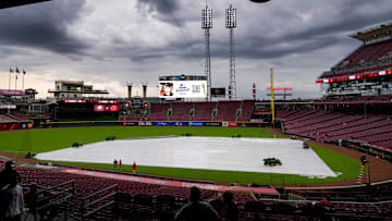 Fans make their ways into the stadium as a rain delay 