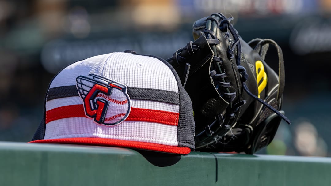 Jul 8, 2024; Detroit, Michigan, USA; A Cleveland Guardians baseball cap and glove sit on the dugout rail before the game against the Detroit Tigers at Comerica Park. Mandatory Credit: David Reginek-Imagn Images Jul 8, 2024; Detroit, Michigan, USA; A Cleveland Guardians baseball cap and glove sit on the dugout rail before the game against the Detroit Tigers at Comerica Park. Mandatory Credit: David Reginek-Imagn Images