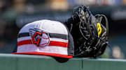 Jul 8, 2024; Detroit, Michigan, USA; A Cleveland Guardians baseball cap and glove sit on the dugout rail before the game against the Detroit Tigers at Comerica Park. Mandatory Credit: David Reginek-Imagn Images