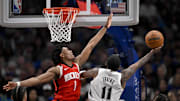 Feb 8, 2025; Dallas, Texas, USA; Dallas Mavericks guard Kyrie Irving (11) and Houston Rockets forward Amen Thompson (1) in action during the game between the Dallas Mavericks and the Houston Rockets at the American Airlines Center. Mandatory Credit: Jerome Miron-Imagn Images