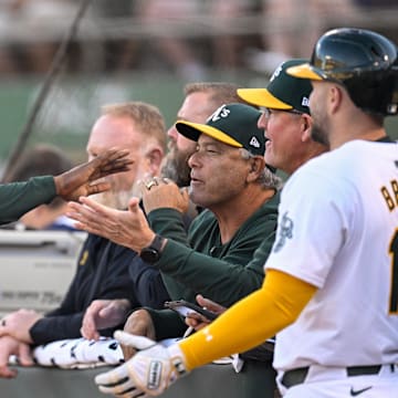 Sep 4, 2024; Oakland, California, USA; Oakland Athletics outfielder Lawrence Butler (left) celebrates his run against the Seattle Mariners in the first inning at Oakland-Alameda County Coliseum.