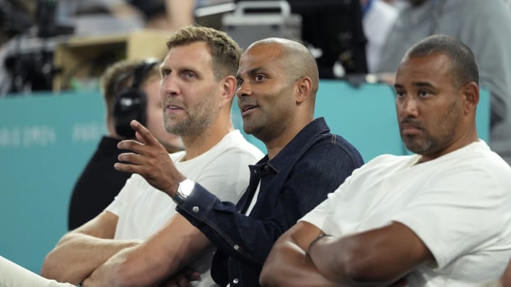 Aug 8, 2024; Paris, France; Former NBA players Dirk Nowitzki (left) and Tony Parker (center) look on during the first half between France and Germany in a men's basketball semifinal game during the Paris 2024 Olympic Summer Games at Accor Arena. Mandatory Credit: Kyle Terada-USA TODAY Sports