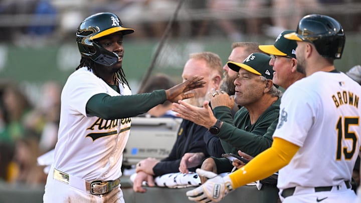 Sep 4, 2024; Oakland, California, USA; Oakland Athletics outfielder Lawrence Butler (left) celebrates his run against the Seattle Mariners in the first inning at Oakland-Alameda County Coliseum.