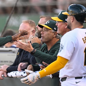 Sep 4, 2024; Oakland, California, USA; Oakland Athletics outfielder Lawrence Butler (left) celebrates his run against the Seattle Mariners in the first inning at Oakland-Alameda County Coliseum. Mandatory Credit: Eakin Howard-Imagn Images