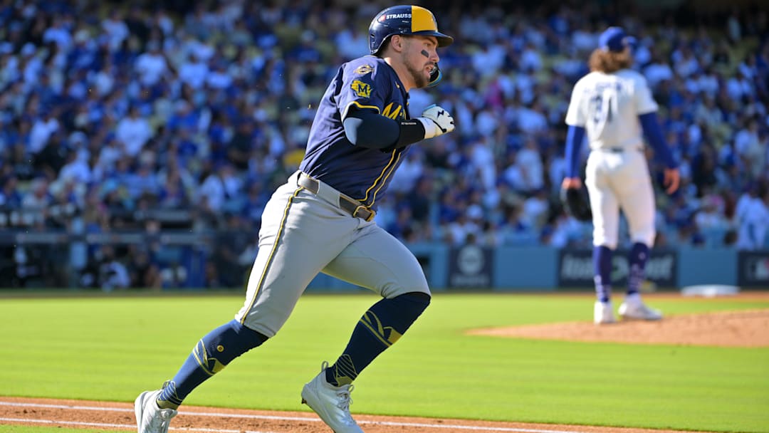 Oct 16, 2025; Los Angeles, California, USA; Milwaukee Brewers third baseman Caleb Durbin (21) runs after hitting a triple against the Los Angeles Dodgers in the second inning during game three of the NLCS round for the 2025 MLB playoffs at Dodger Stadium. Mandatory Credit: Jayne Kamin-Oncea-Imagn Images
