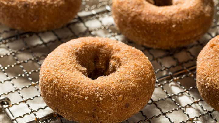 Freshly made apple cider doughnuts dusted with cinnamon sugar. Freshly made apple cider doughnuts dusted with cinnamon sugar.