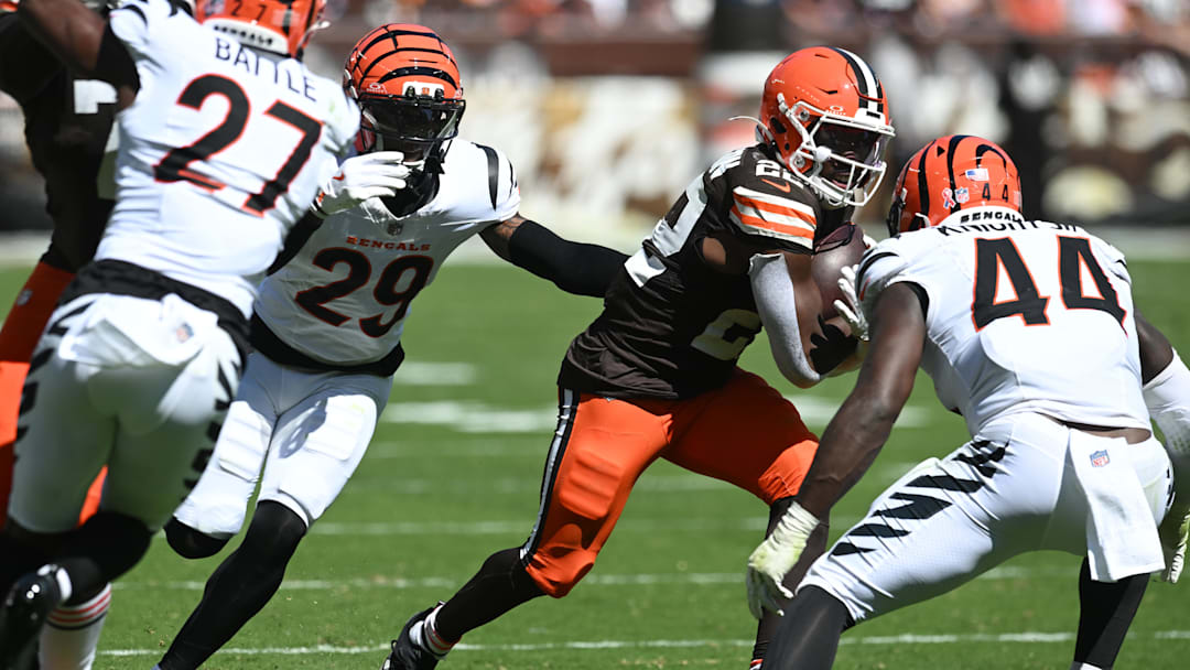 Sep 7, 2025; Cleveland, Ohio, USA; Cleveland Browns running back Dylan Sampson (22) runs against Cincinnati Bengals cornerback Cam Taylor-Britt (29) and linebacker Demetrius Knight Jr. (44)  during the second half at Huntington Bank Field. Mandatory Credit: Ken Blaze-Imagn Images