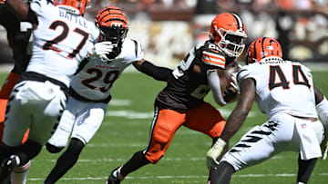 Sep 7, 2025; Cleveland, Ohio, USA; Cleveland Browns running back Dylan Sampson (22) runs against Cincinnati Bengals cornerback Cam Taylor-Britt (29) and linebacker Demetrius Knight Jr. (44)  during the second half at Huntington Bank Field. Mandatory Credit: Ken Blaze-Imagn Images