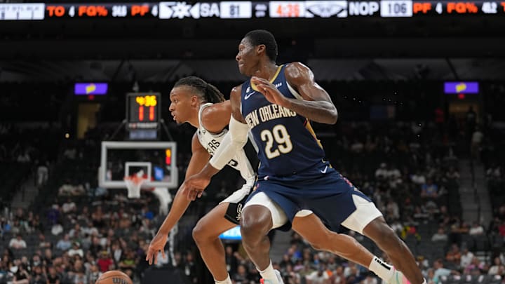 Oct 9, 2022; San Antonio, Texas, USA; San Antonio Spurs guard Romeo Langford (35) dribbles past New Orleans Pelicans guard Daeqwon Plowden (29) in the second half at the AT&T Center. Mandatory Credit: Daniel Dunn-Imagn Images