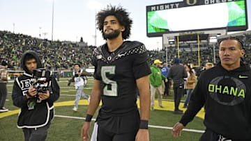 Nov 22, 2025; Eugene, Oregon, USA; Oregon Ducks quarterback Dante Moore (5) walks off the field after the game against the Southern California Trojans at Autzen Stadium. Mandatory Credit: Troy Wayrynen-Imagn Images