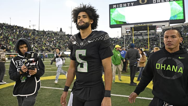Nov 22, 2025; Eugene, Oregon, USA; Oregon Ducks quarterback Dante Moore (5) walks off the field after the game against the Southern California Trojans at Autzen Stadium. Mandatory Credit: Troy Wayrynen-Imagn Images