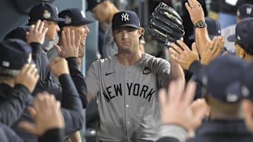 Oct 25, 2024; Los Angeles, California, USA; New York Yankees starting pitcher Gerrit Cole (45) receives congratulations in the dugout in the seventh inning against the Los Angeles Dodgers during game one of the 2024 MLB World Series at Dodger Stadium. Mandatory Credit:  Jayne Kamin-Oncea-Imagn Images