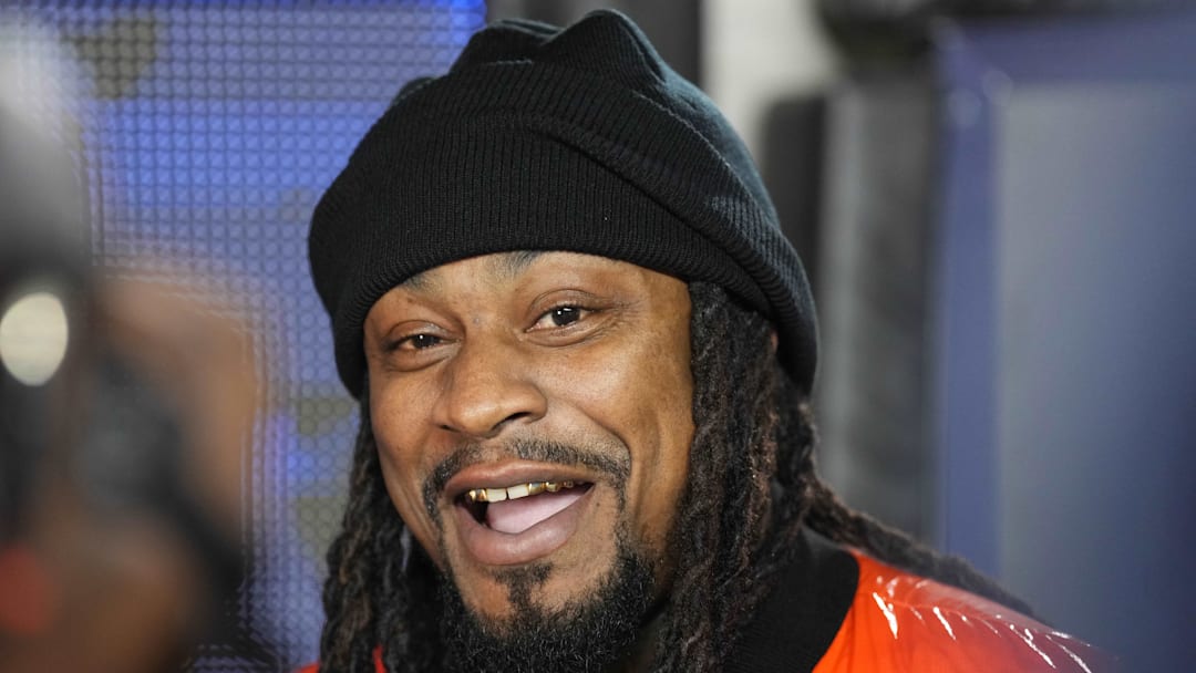 Oct 22, 2022; Berkeley, California, USA; California Golden Bears former running back Marshawn Lynch is interviewed on the sideline during the second quarter of the game between the California Golden Bears and the Washington Huskies at FTX Field at California Memorial Stadium. Mandatory Credit: Darren Yamashita-Imagn Images