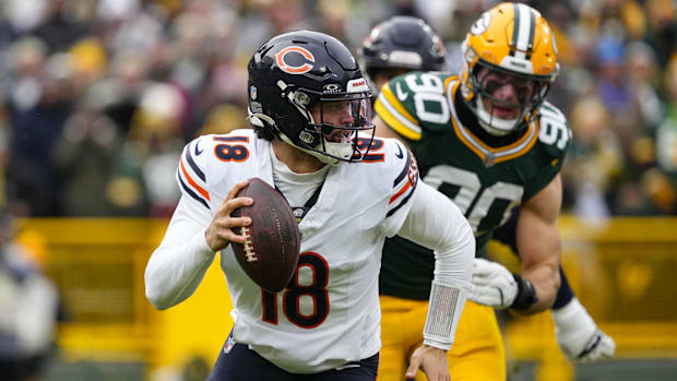 Chicago Bears quarterback Caleb Williams (18) scrambles away from pressure applied by Green Bay Packers.