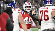 Dec 1, 2025; Foxborough, Massachusetts, USA; New England Patriots linebacker Jahlani Tavai (48) and New York Giants guard Jon Runyan (76) get into an argument after a hit on New York Giants quarterback Jaxson Dart (6) during the first quarter at Gillette Stadium. Mandatory Credit: Eric Canha-Imagn Images