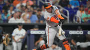 Jul 25, 2024; Miami, Florida, USA;  Baltimore Orioles catcher James McCann (27) hits an a single to score a run against the Miami Marlins in the second inning at loanDepot Park. Mandatory Credit: Jim Rassol-USA TODAY Sports