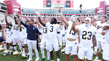 Sep 27, 2025; Fayetteville, Arkansas, USA; Notre Dame Fighting Irish head coach Marcus Freeman leads the team in celebration after the game against the Arkansas Razorbacks at Donald W. Reynolds Razorback Stadium. Notre Dame won 56-13. Mandatory Credit: Nelson Chenault-Imagn Images
