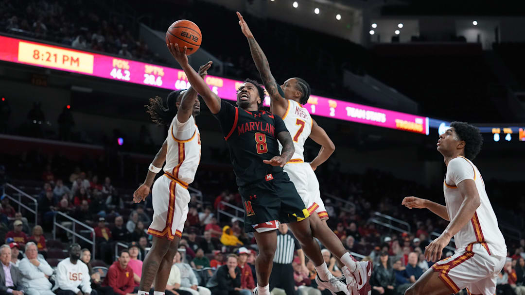 Jan 13, 2026; Los Angeles, California, USA; Maryland Terrapins guard David Coit (8) shoots the ball against Southern California Trojans guard Kam Woods (13) and guard Jordan Marsh (7) in the first half at Galen Center. Mandatory Credit: Kirby Lee-Imagn Images